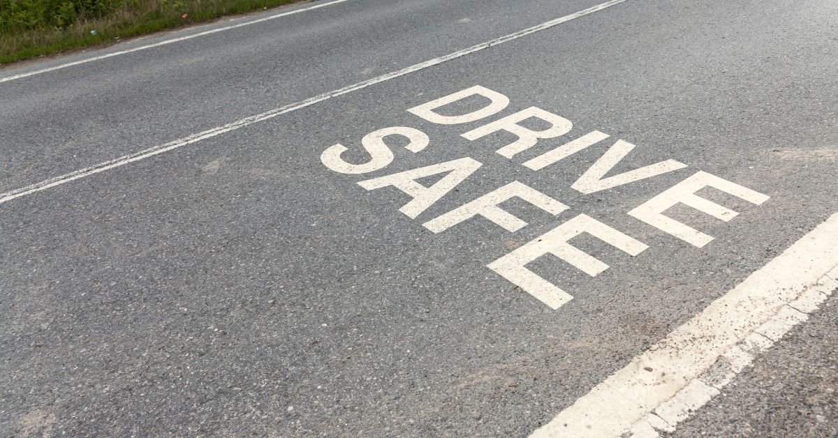 The phrase "Drive Safe" written on a road.