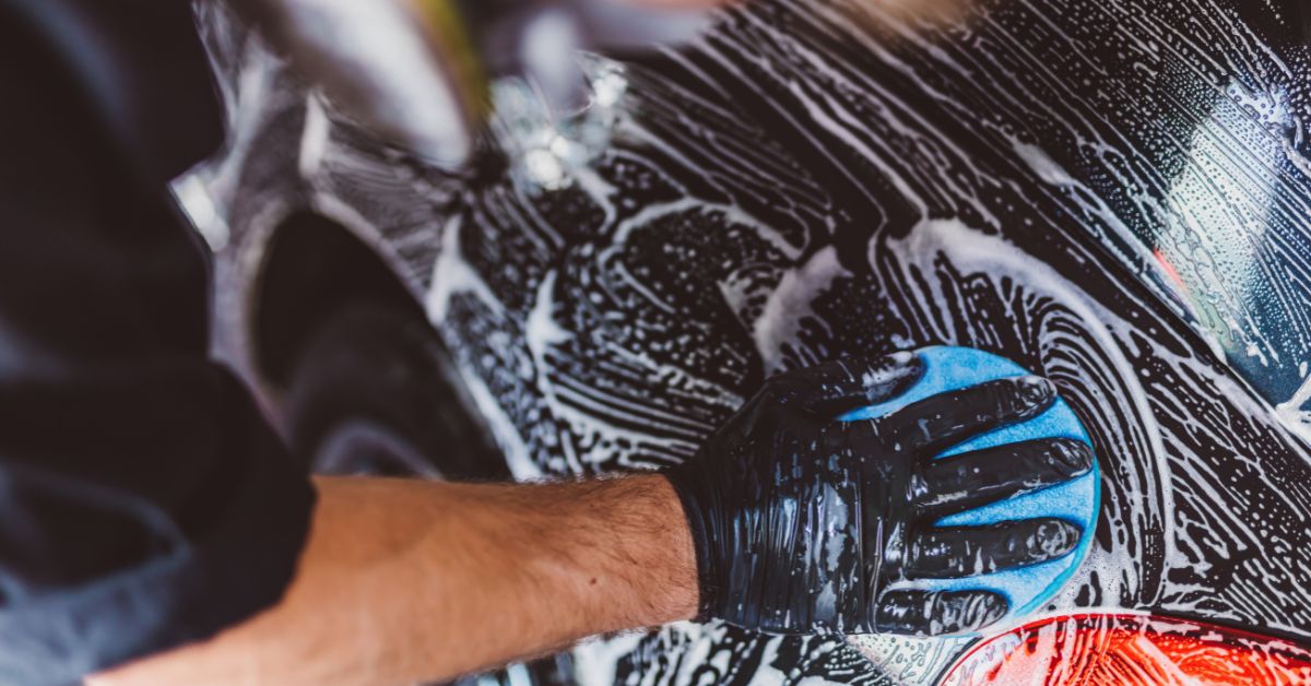 A professional washing a car before detailing.